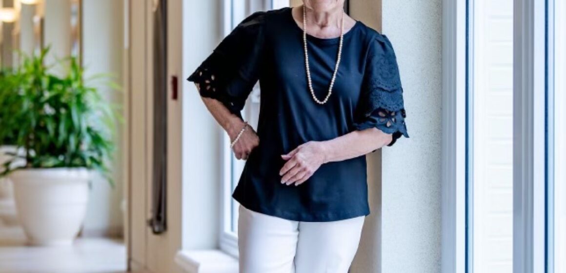 Woman smiling in hallway