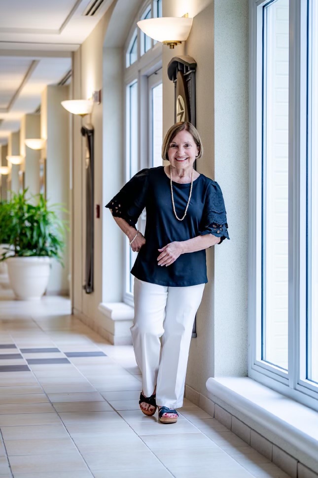 Woman smiling in hallway