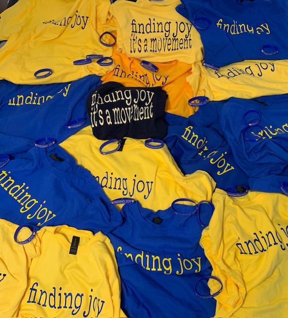 Finding Joy T shirts scattered